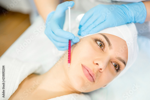 A cosmetologist performs an injection procedure. Cosmetology clinic.