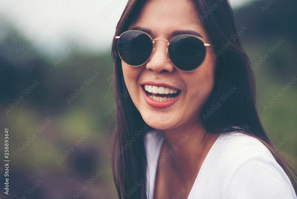 Portrait of pretty young Asian woman standing outdoors, smile and happy Portrait of pretty young Asian woman standing outdoors, smile and happy