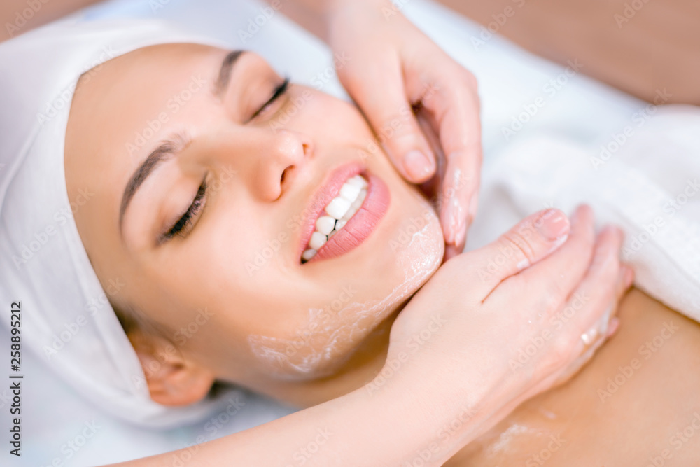 Cosmetology. The hands of a cosmetologist do a facial massage with a mask. Spa procedure. Cosmetology. The hands of a cosmetologist do a facial massage with a mask. Spa procedure.