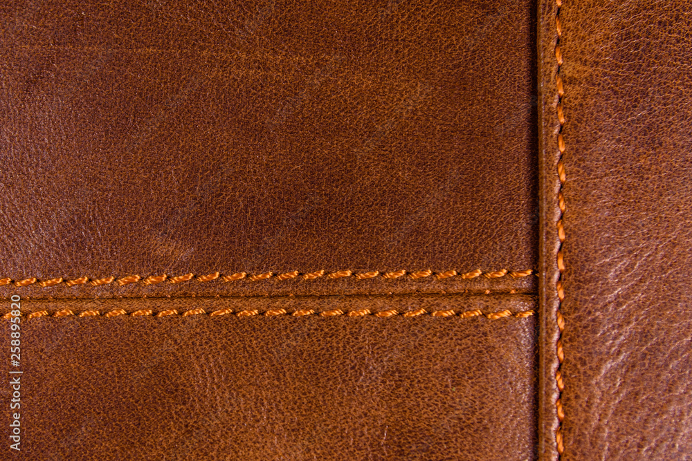 Texture of the natural brown leather and stitches Texture of the natural brown leather and stitches