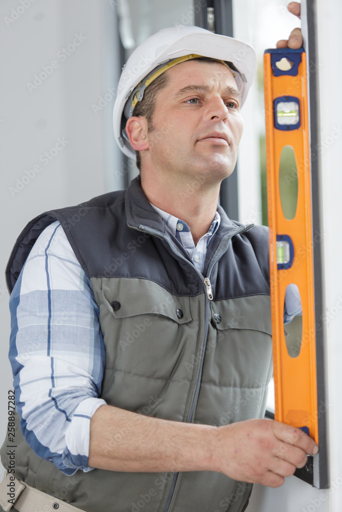 repairman using a builder level repairman using a builder level