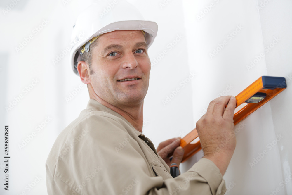 mature man using a spirit level mature man using a spirit level