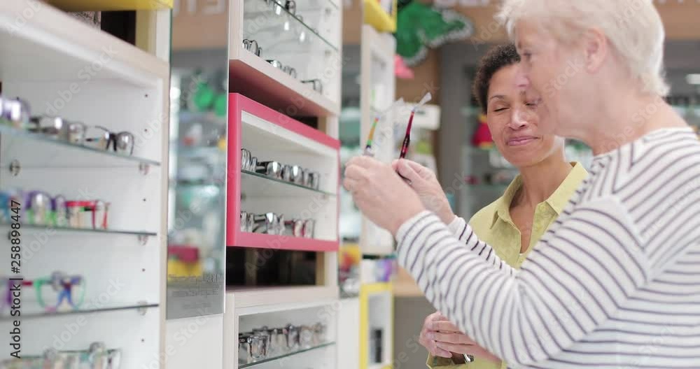 Optician advising customer on spectacles Optician advising customer on spectacles