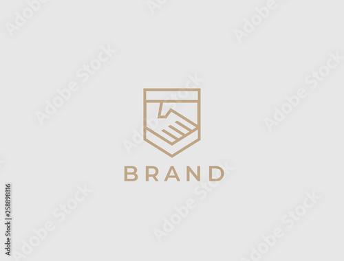 Abstract handshake business logo, vector logo. Two hands make a deal on the shield background. Trust, friendship, partnership, agreement, business, success, money, deal, contract, team, symbol icon.