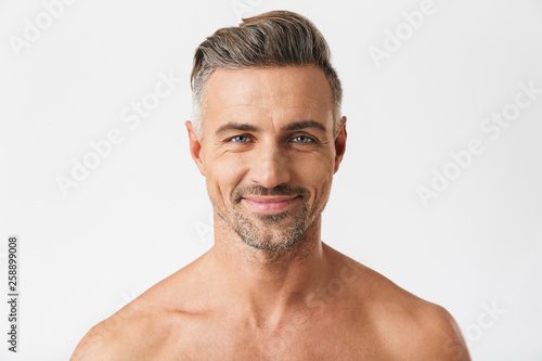 Closeup portrait of european half naked man 30s having bristle smiling at camera