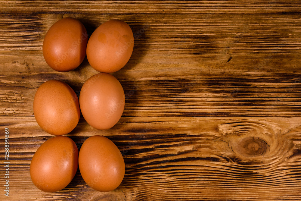 Pile of the hen eggs on wooden table. Top view Pile of the hen eggs on wooden table. Top view