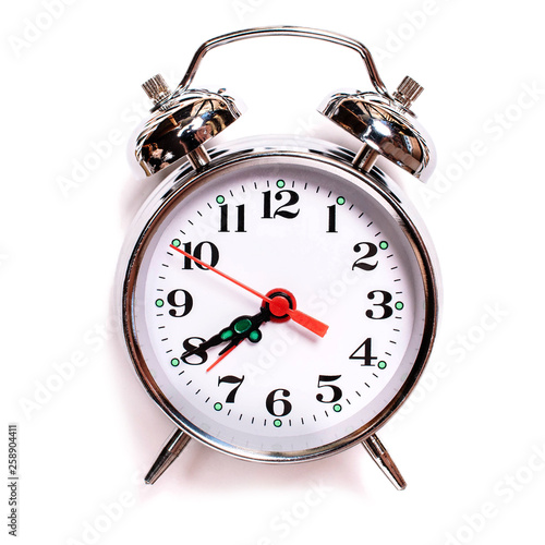 solated vintage analog alarm clock on a white background. Seven forty am on alarm clock