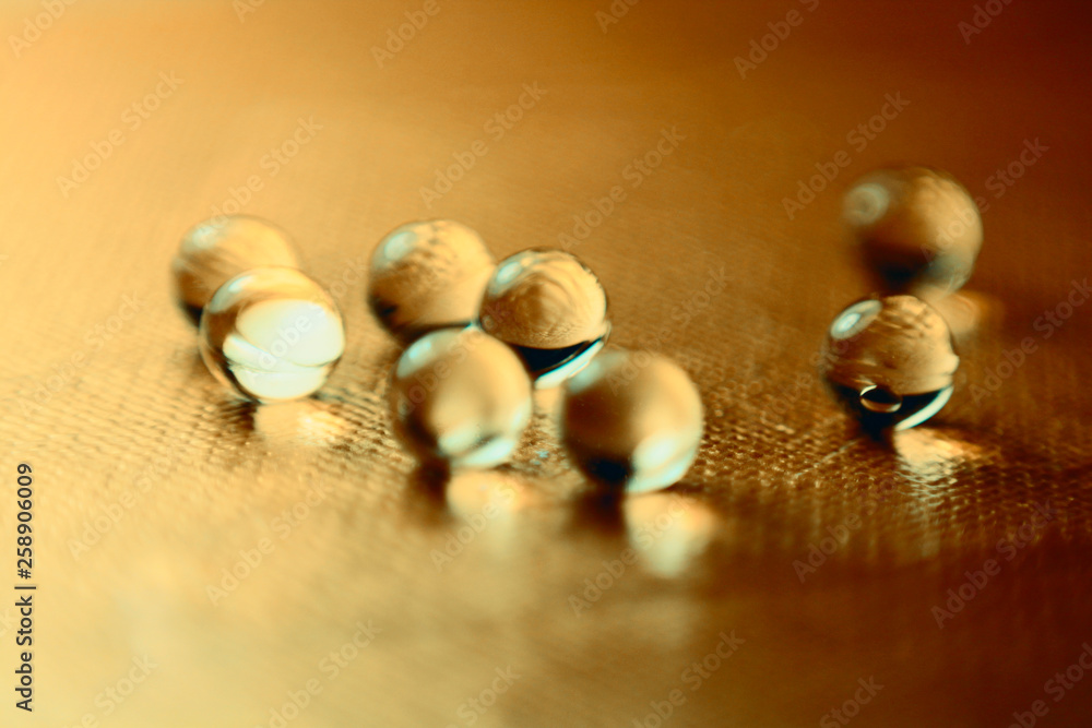 heap of round pills on golden metallic background
