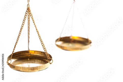 Justice law judge brass balance scales on white background. Close up with free space.