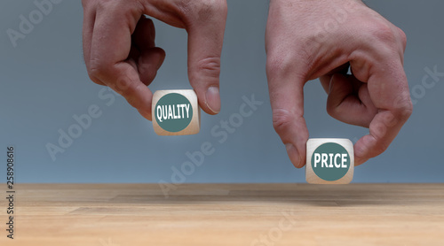 Symbol for choosing quality instead of a cheap price. Two Hands hold two dice with the words 