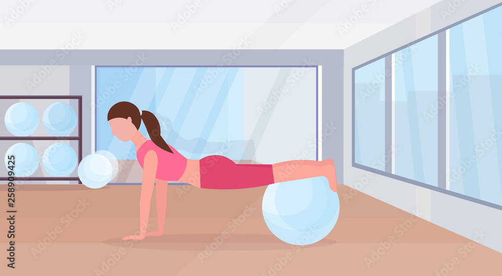 Fototapeta premium sporty woman doing exercises with fitness ball girl training in gym aerobic pilates workout healthy lifestyle concept flat modern health club studio interior horizontal