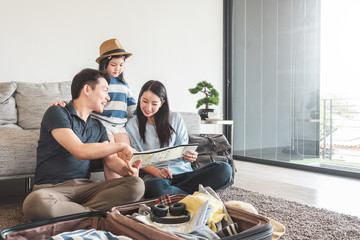 Asian family packing bag/luggage and planning to travel on summer vacation
