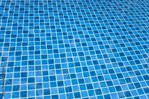 Swimming pool bottom with clear water surface textured background.