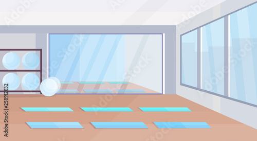 yoga studio healthy lifestyle concept empty no people gym interior design with mats fit balls mirror and windows horizontal