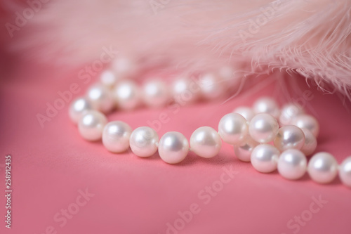 Pearl necklace on a gently pink background