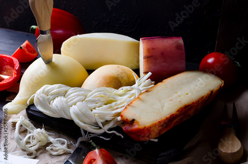 Assorted cheeses in various shapes and sizes photo