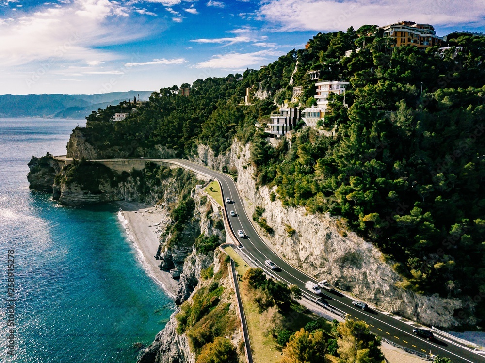Aerial view of road going through beautiful landscape by the sea in Italy