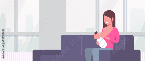 happy mother breastfeeding her newborn baby son woman sitting on couch motherhood nutrition lactation concept living room interior flat portrait horizontal