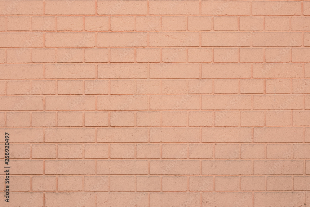 Texture of light orange brick wall. Blank space. Coral stone background. Brick pattern on coral backdrop. Yellow concrete texture. Texture of light orange brick wall. Blank space. Coral stone background. Brick pattern on coral backdrop. Yellow concrete texture.