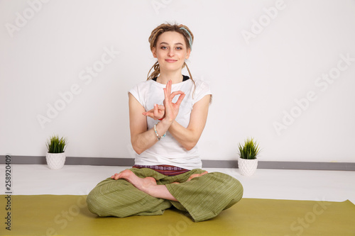 Female model in yoga pose in the studio. Young woman doing exercises. Relax.