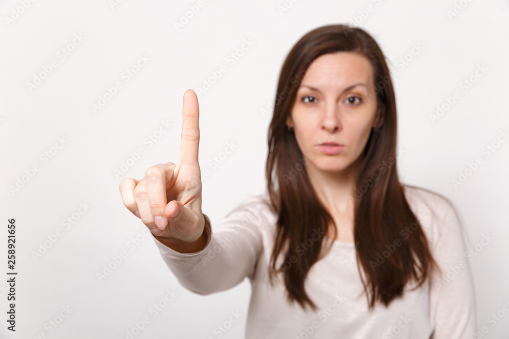 Yyoung woman touch something like push click on button pointing at floating virtual screen isolated on white wall background in studio. People sincere emotions lifestyle concept. Mock up copy space. Yyoung woman touch something like push click on button pointing at floating virtual screen isolated on white wall background in studio. People sincere emotions lifestyle concept. Mock up copy space.