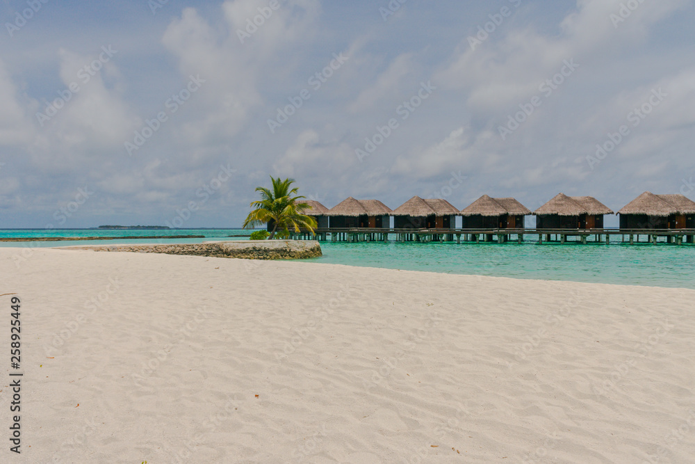 Amazing island in the Maldives  , beautiful  turquoise waters with  blue sky  background for holiday vacation .