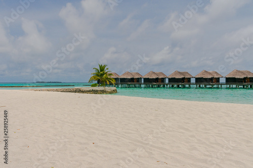 Amazing island in the Maldives , beautiful turquoise waters with blue sky background for holiday vacation .