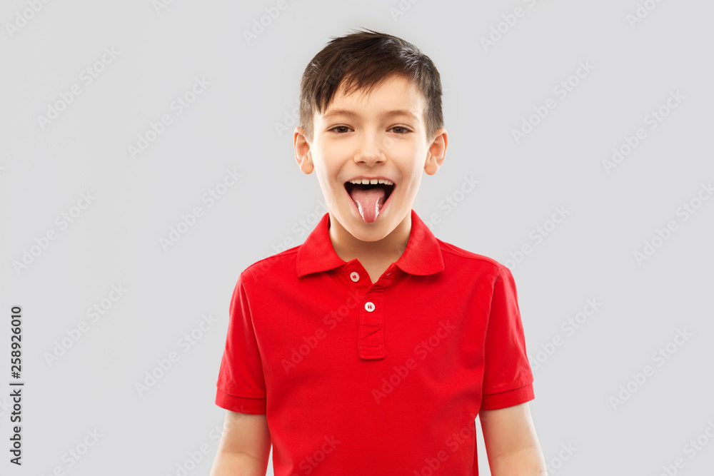 childhood, expressions and fun concept happy little boy in red polo t