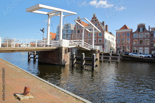 Gravestenenbrug bridge over Spaarne river and with traditional houses in the background, Haarlem, Netherlands photo