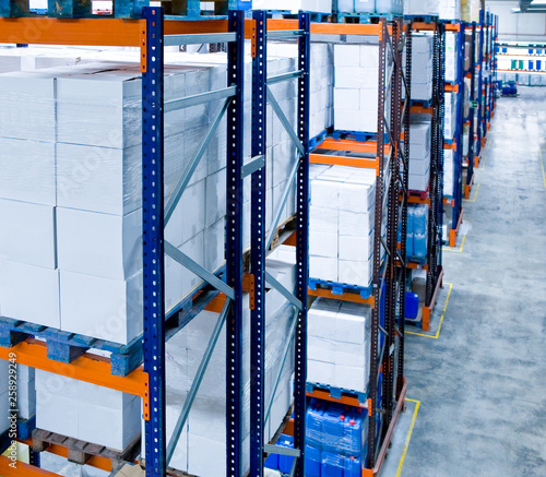 Pallets with boxes and drums in the warehouse