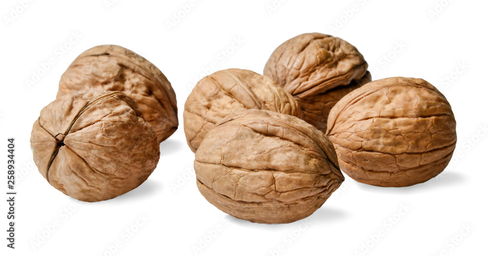 Several walnuts on a white isolated background. Close-up. Side view. Several walnuts on a white isolated background. Close-up. Side view.