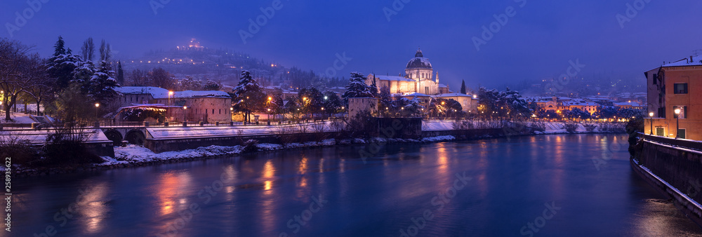 Verona at night with snow - Adige river Italy