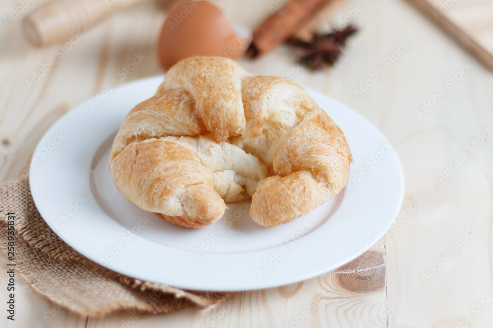 Croissant on wooden table wood and fabric select focus shallow depth of field Croissant on wooden table wood and fabric select focus shallow depth of field