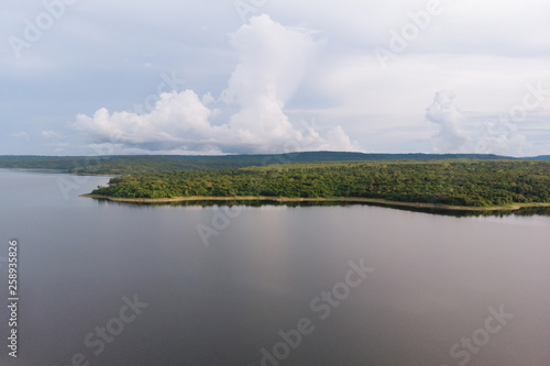 Drone shot Aerial view landscape scenic of big river reservoir with forest and mountains in tropical land