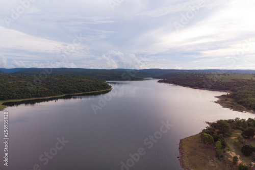 Drone shot Aerial view landscape scenic of big river reservoir with nature forest and mountains in tropical land
