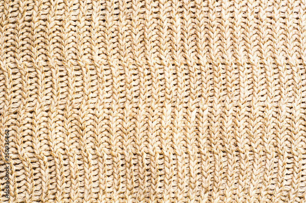 Texture of knitted sweater as a background. Beige color. Close up Texture of knitted sweater as a background. Beige color. Close up