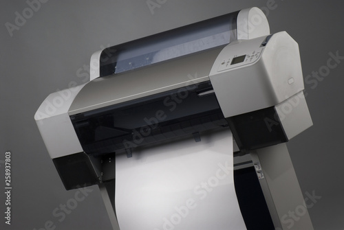 Large format inkjet printer on gray background photo