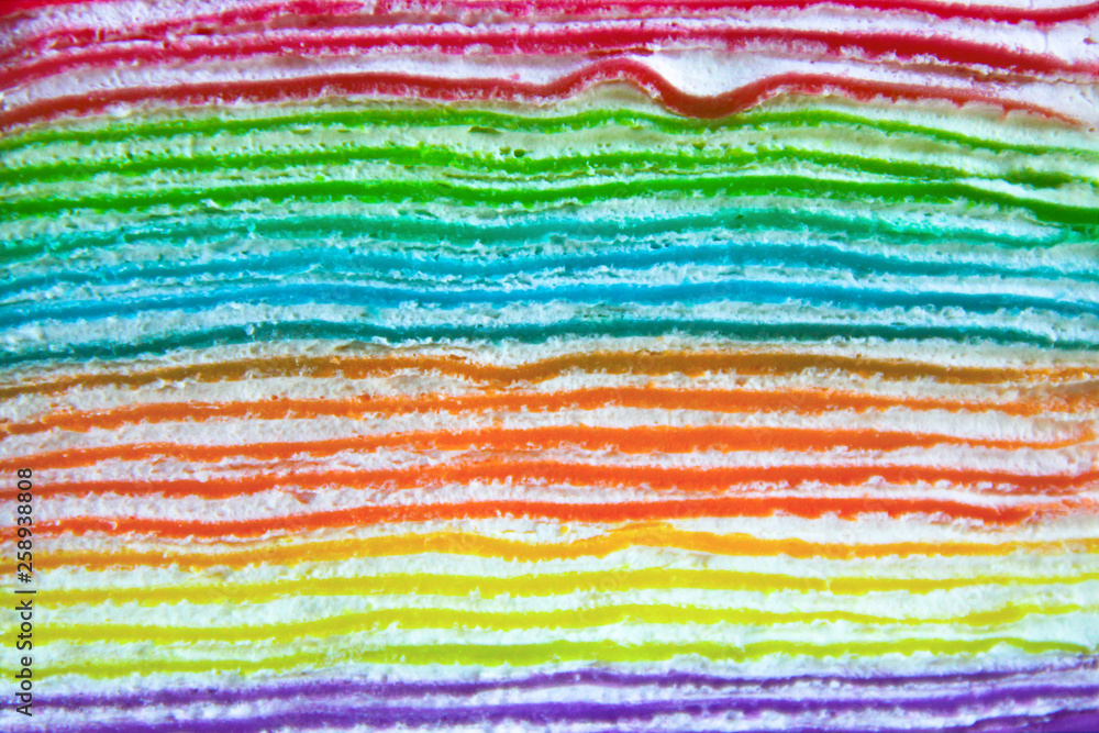 Close-up of colorful rainbow crepe cake layers 