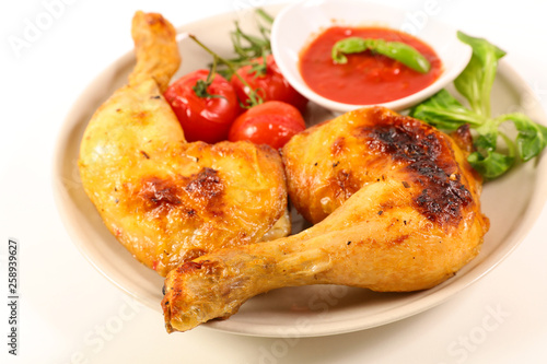 grilled chicken leg and tomato sauce isolated on white background