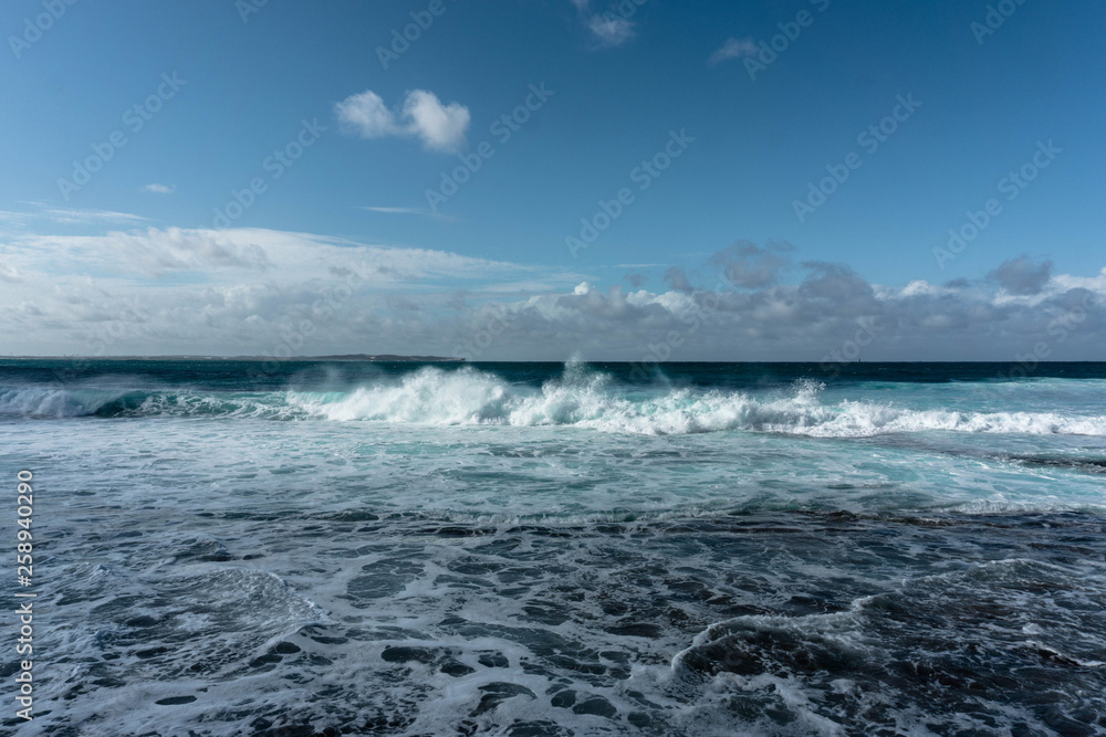 waves in the ocean and blue sky