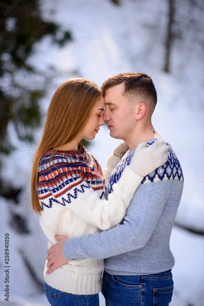 outdoor fashion portrait of young sensual couple in cold winter wather. love and kiss outdoor fashion portrait of young sensual couple in cold winter wather. love and kiss