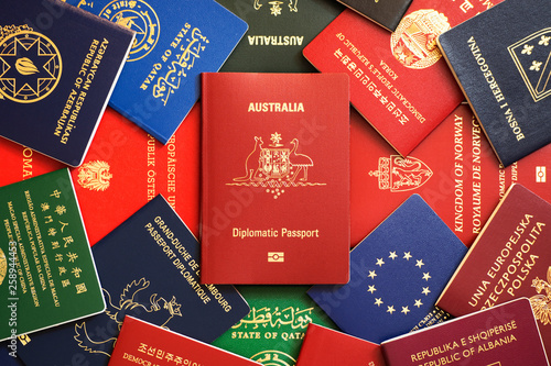Australia's red biometric diplomatic passport among multicolored passports of many countries of the world
