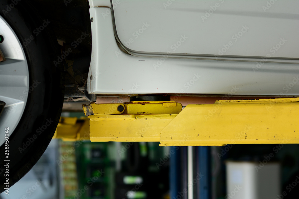 the yellow lift hand at the lifting safety mark under the car the yellow lift hand at the lifting safety mark under the car