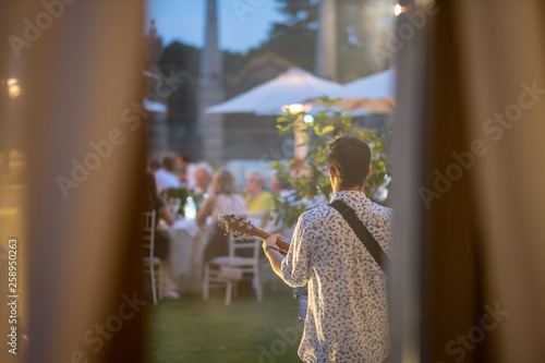 Musician is playing at a wedding photo