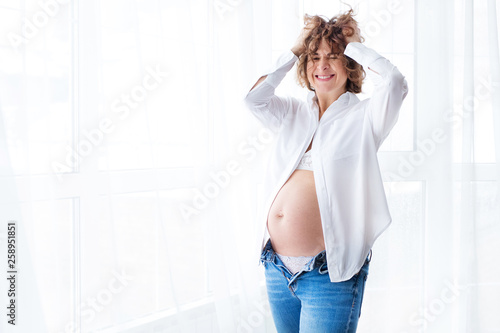 beautiful pregnant girl resting at home. beautiful pregnant girl posing on camera photo