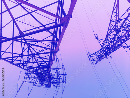 Evening high voltage power lines, electricity towers / pylons, diminishing perspective,  duotone abstract industrial background
