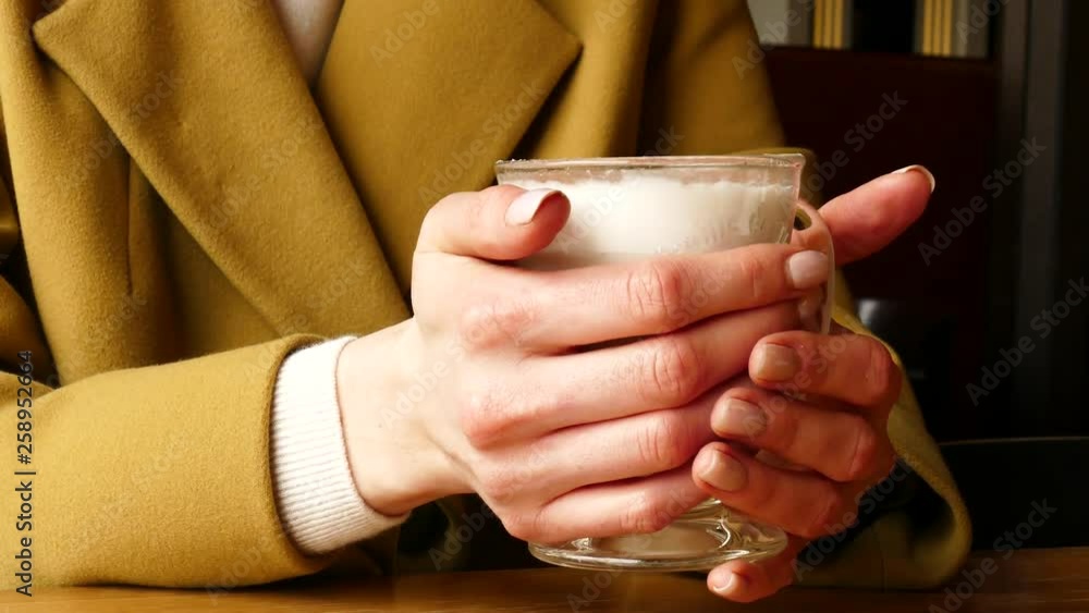 Woman hold Coffee Latte From Glass Cup Close Up Woman hold Coffee Latte From Glass Cup Close Up