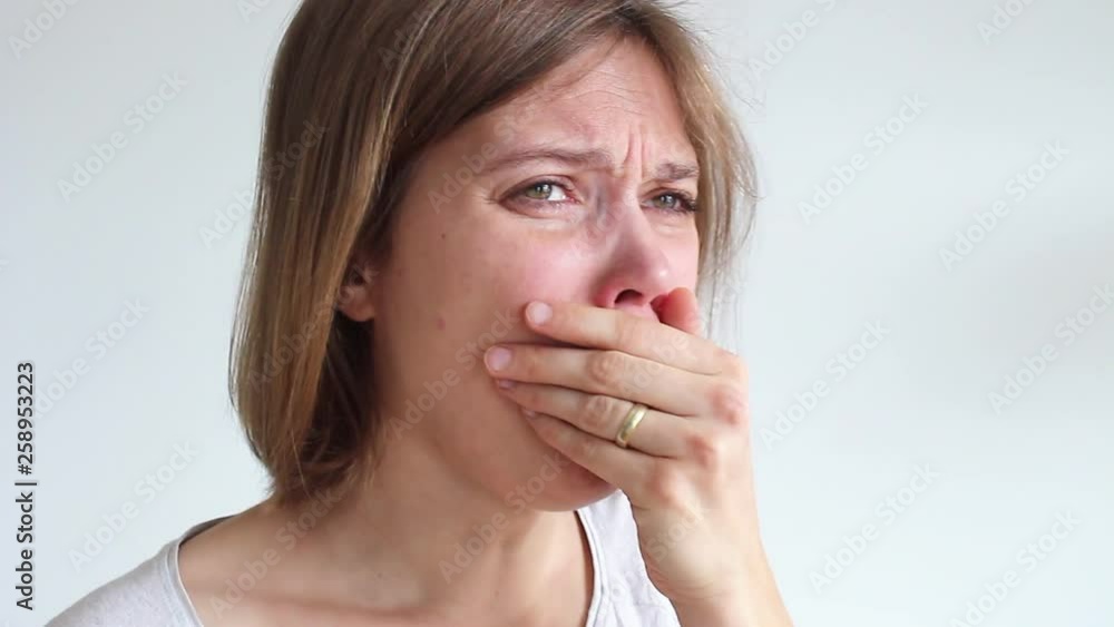sick young millenial woman coughing and spreading infection on white background. Young beautiful woman covering her mouth with hand while coughing. Young Female having virus, cold or flu symptoms sick young millenial woman coughing and spreading infection on white background. Young beautiful woman covering her mouth with hand while coughing. Young Female having virus, cold or flu symptoms