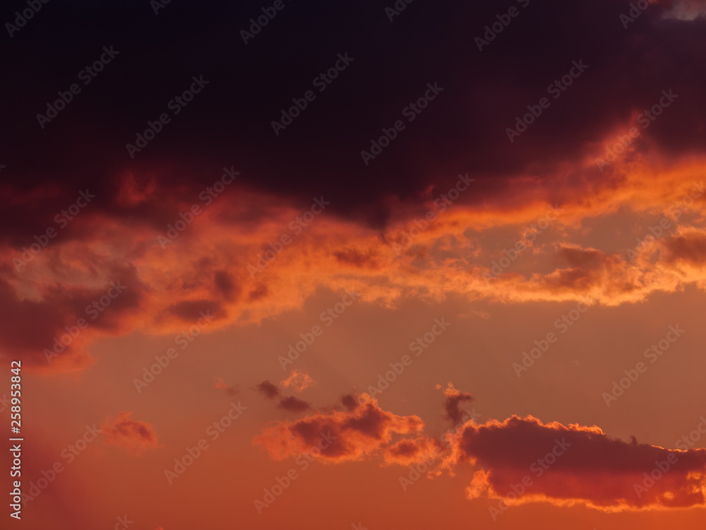 Dramatic sunset sky with orange clouds.