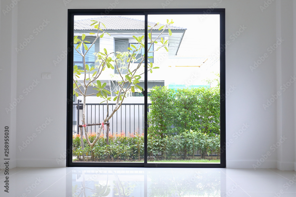 slide glass door with small garden landscaping in front of a new house